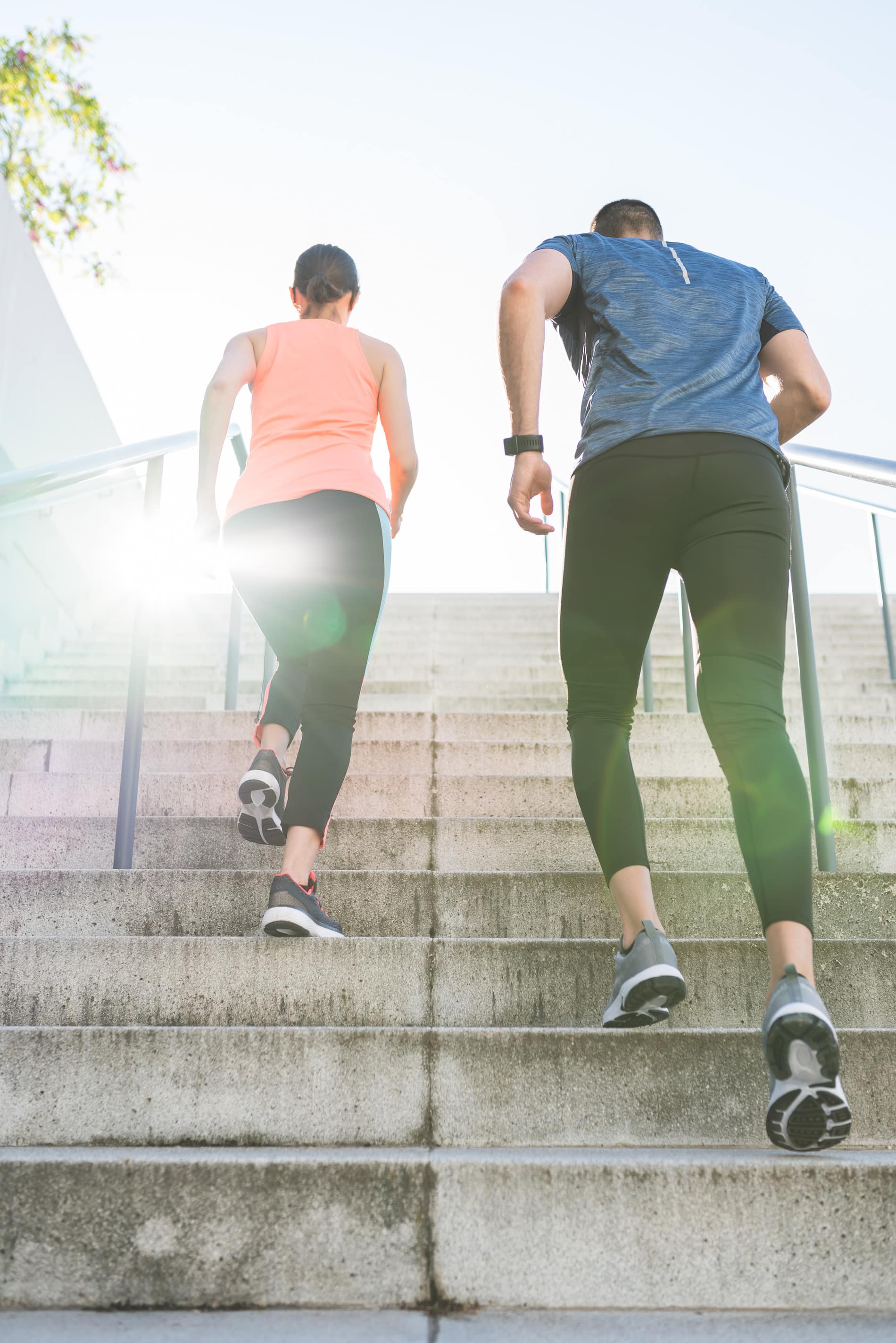 Man and woman run up the stairs after functional medicine in Charlotte, NC