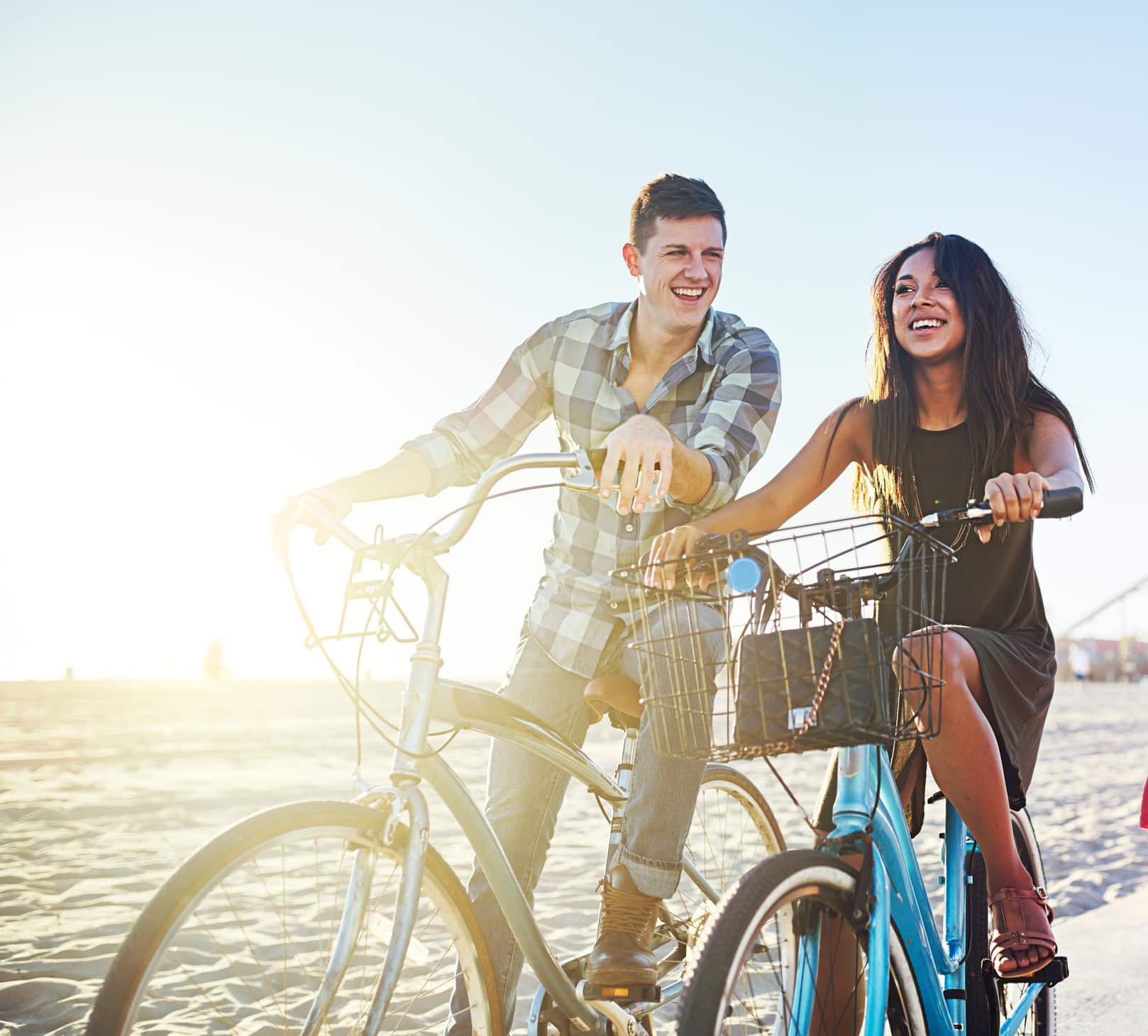 Couple riding bikes without pain after pain relief treatment in Charlotte